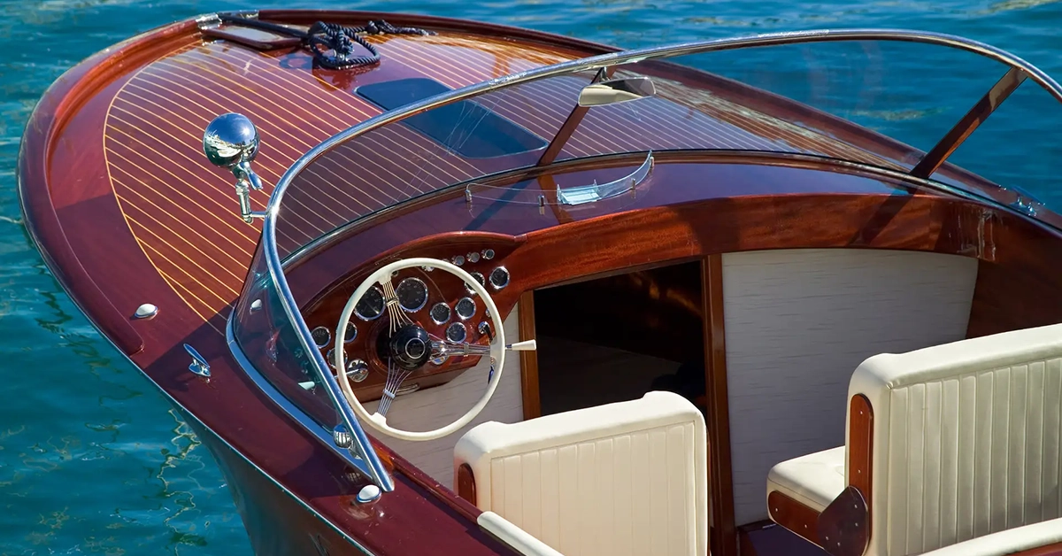 Classic wooden luxury boat docked on clear blue water near Naples waterfront