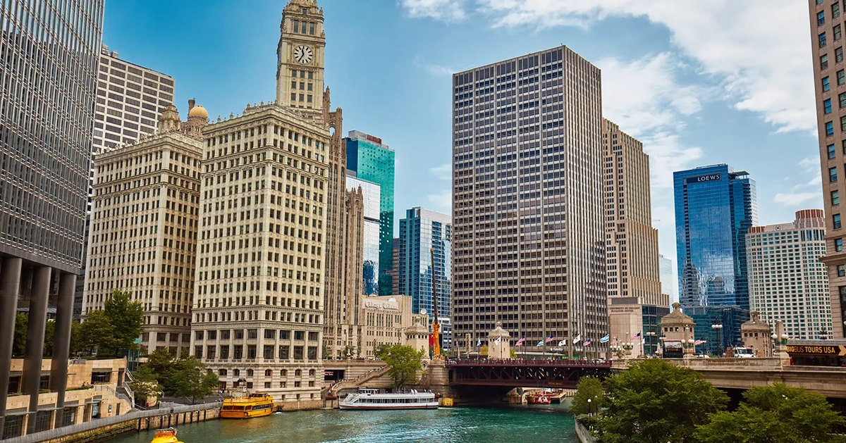 City skyline along a riverfront illustrating the connection between urban life and waterfront living