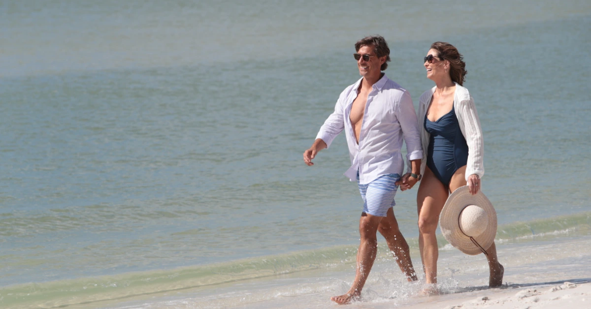 Couple walking along Naples Florida beach shoreline