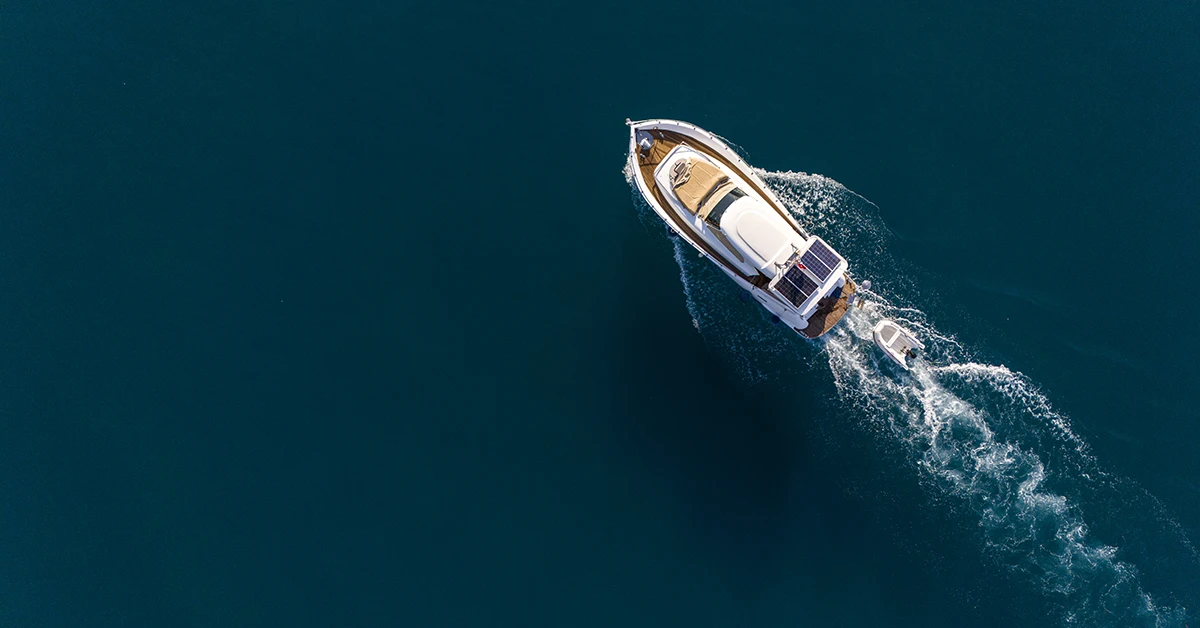 Aerial view of boat moving through ocean