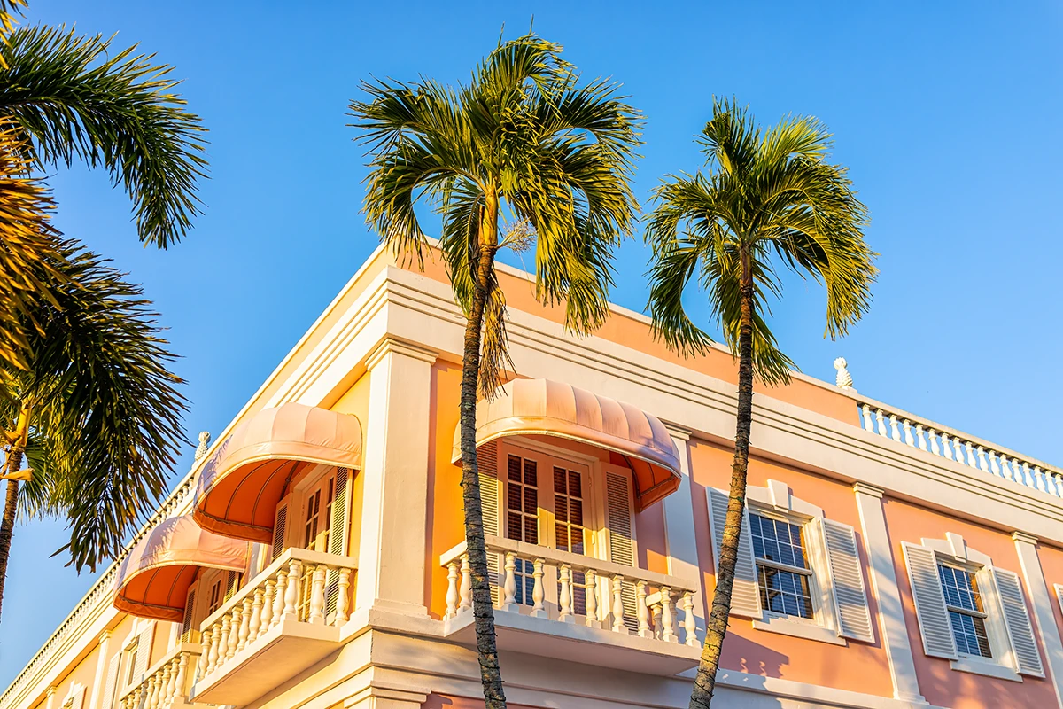 Tropical building with palm trees and balconies